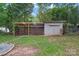 Backyard featuring a shed, partial privacy fencing, and an adjacent covered structure at 2401 Woodleaf Dr, Gastonia, NC 28052