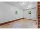 Spacious basement featuring concrete floors, brick base trim, dual windows, and white walls at 2401 Woodleaf Dr, Gastonia, NC 28052