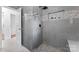 Modern bathroom with gray tile, a walk-in shower with neutral accents, and updated fixtures at 2401 Woodleaf Dr, Gastonia, NC 28052