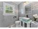 Stylish bathroom featuring gray tile, a vessel sink, modern fixtures, and a window for natural light at 2401 Woodleaf Dr, Gastonia, NC 28052