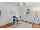 Bright bedroom featuring hardwood floors, ceiling fan, a desk, and a large window offering ample natural light at 2401 Woodleaf Dr, Gastonia, NC 28052