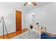 Cozy bedroom featuring hardwood floors, ceiling fan, a desk, and a closet for optimal storage solutions at 2401 Woodleaf Dr, Gastonia, NC 28052