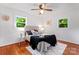 Inviting bedroom with natural lighting, hardwood floors, a ceiling fan, and a cozy bed setting at 2401 Woodleaf Dr, Gastonia, NC 28052