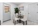 Bright dining area features a black table, white chairs, an indoor plant, and neutral decor for inviting meals at 2401 Woodleaf Dr, Gastonia, NC 28052