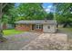 Beautiful one-story home featuring a brick facade, chimney, and a leaf-covered driveway at 2401 Woodleaf Dr, Gastonia, NC 28052