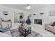 Bright living room with a fireplace, modern lighting, and view into the dining area at 2401 Woodleaf Dr, Gastonia, NC 28052