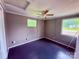 This bedroom features neutral-toned walls, ceiling fan, and two windows for natural light at 2634 E Greenbriar Rd, Statesville, NC 28625