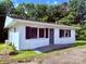 View of the property showcasing its pristine white facade and complementary dark shutters at 2634 E Greenbriar Rd, Statesville, NC 28625