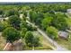 An aerial view shows a house nestled among mature trees and a quiet neighborhood street at 304 Miller Ave, Salisbury, NC 28144