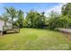 Large, grassy backyard with mature trees and lush greenery at 304 Miller Ave, Salisbury, NC 28144
