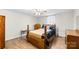Comfortable bedroom with wood floors, vintage furniture, cozy bed and dresser at 304 Miller Ave, Salisbury, NC 28144