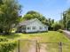 View of the house in a grassy front yard with a gated driveway at 304 Miller Ave, Salisbury, NC 28144