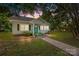 Charming single-story home with a quaint front porch, complemented by lush greenery and a serene atmosphere at 304 Miller Ave, Salisbury, NC 28144