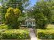 A quaint home with a neatly manicured front yard and a charming walkway leading to the front door at 304 Miller Ave, Salisbury, NC 28144
