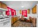 Kitchen featuring classic appliances, tile floors, a table and bright red curtains at 304 Miller Ave, Salisbury, NC 28144
