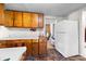 Cozy kitchen with wooden cabinets and a white refrigerator at 304 Miller Ave, Salisbury, NC 28144