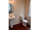 Powder room featuring wood flooring, toilet, and pedestal sink at 318 Linsbury Ct, Gastonia, NC 28056
