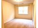 Neutral bedroom with tan carpet, cream walls and a window to let light in at 318 Linsbury Ct, Gastonia, NC 28056