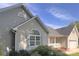 The exterior showing a large arched window, neutral vinyl siding, and a white columned front porch at 318 Linsbury Ct, Gastonia, NC 28056