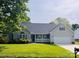 Charming single-story home featuring a covered porch, well-manicured lawn, and attached two-car garage at 318 Linsbury Ct, Gastonia, NC 28056