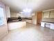 The kitchen features white cabinetry, an island with bar seating, and plenty of counter space for cooking at 318 Linsbury Ct, Gastonia, NC 28056
