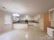 Spacious kitchen area featuring tile floors, white cabinetry, and modern appliances; a perfect hub for cooking and gathering at 318 Linsbury Ct, Gastonia, NC 28056