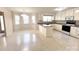 Bright kitchen showcasing white cabinets, tile floors, breakfast bar, and an adjacent dining area, ideal for entertaining at 318 Linsbury Ct, Gastonia, NC 28056