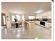 Open-concept kitchen and dining area with white cabinetry, a breakfast bar, and tile flooring at 318 Linsbury Ct, Gastonia, NC 28056