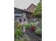 Spacious backyard featuring a brick fireplace, covered parking, lush landscaping and outdoor seating at 324 N 5Th St, Albemarle, NC 28001