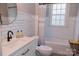 Bathroom featuring white vanity, toilet, and tub with white subway tile at 324 N 5Th St, Albemarle, NC 28001