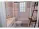 Bathroom with white vanity, toilet, and tub with white subway tile at 324 N 5Th St, Albemarle, NC 28001