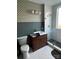 Bathroom featuring modern fixtures, tiled shower, pedestal sink, and unique wallpaper at 324 N 5Th St, Albemarle, NC 28001