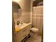 Bathroom features a modern sink vanity, round mirror, subway tiles, and stylish black and white tile floors at 324 N 5Th St, Albemarle, NC 28001
