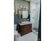 Bathroom featuring dark wood vanity, vessel sink, elegant mirror, and subway tile shower at 324 N 5Th St, Albemarle, NC 28001