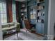 Stylish den featuring hardwood floors, built-in bookshelves, and ample natural light at 324 N 5Th St, Albemarle, NC 28001