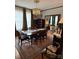 Classic dining room featuring a crystal chandelier, dark wood table, and large windows with natural light at 324 N 5Th St, Albemarle, NC 28001