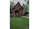 Beautiful brick home featuring an arched porch, black trim, and a well-manicured lawn at 324 N 5Th St, Albemarle, NC 28001