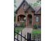 Attractive brick home showcasing a well-maintained front yard, arched porch, and professional landscaping at 324 N 5Th St, Albemarle, NC 28001