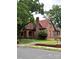 Attractive exterior view featuring brick construction, a clay tile roof, and a well maintained lawn at 324 N 5Th St, Albemarle, NC 28001