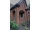 Charming brick home featuring an arched front porch with classic architectural details and landscaping at 324 N 5Th St, Albemarle, NC 28001