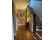 Charming hallway featuring hardwood floors and classic staircase with white railings and wood banister at 324 N 5Th St, Albemarle, NC 28001