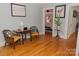 Hallway showcasing hardwood floors, seating, and view into an adjacent bedroom at 324 N 5Th St, Albemarle, NC 28001