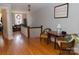 Hallway featuring hardwood floors, railing, and a desk in an adjacent room at 324 N 5Th St, Albemarle, NC 28001