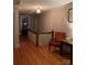 Upstairs hallway with wood floors and vintage-inspired furniture, creating a cozy atmosphere at 324 N 5Th St, Albemarle, NC 28001