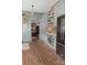 Well-designed kitchen featuring brick flooring, shaker cabinets, wine racks, and connection to other rooms at 324 N 5Th St, Albemarle, NC 28001