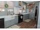 Modern kitchen featuring gray cabinets, a farmhouse sink, and updated appliances, providing a functional space at 324 N 5Th St, Albemarle, NC 28001