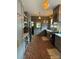 Galley kitchen with brick floors, custom gray cabinets, farmhouse sink, and designer lighting at 324 N 5Th St, Albemarle, NC 28001