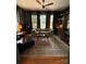 Comfortable living space featuring hardwood floors, built-in shelving, and a sofa near large windows at 324 N 5Th St, Albemarle, NC 28001