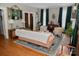 Warm living room featuring hardwood floors, large windows with draped curtains, and ample seating at 324 N 5Th St, Albemarle, NC 28001