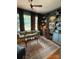 Inviting living room featuring large windows, hardwood floors, custom cabinets, and comfortable seating at 324 N 5Th St, Albemarle, NC 28001